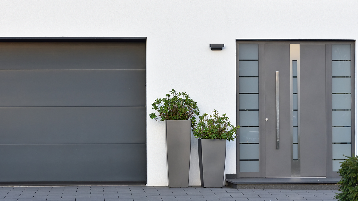 Modern style house with a grey door and garage